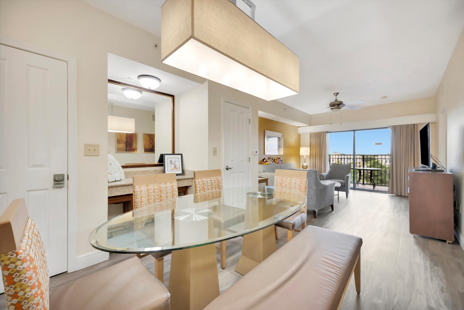 Gather around the glass dining table for meals together, then relax in the open living room with sliding doors that welcome fresh air and views beyond. Everything you need flows seamlessly from one inviting space to the next.