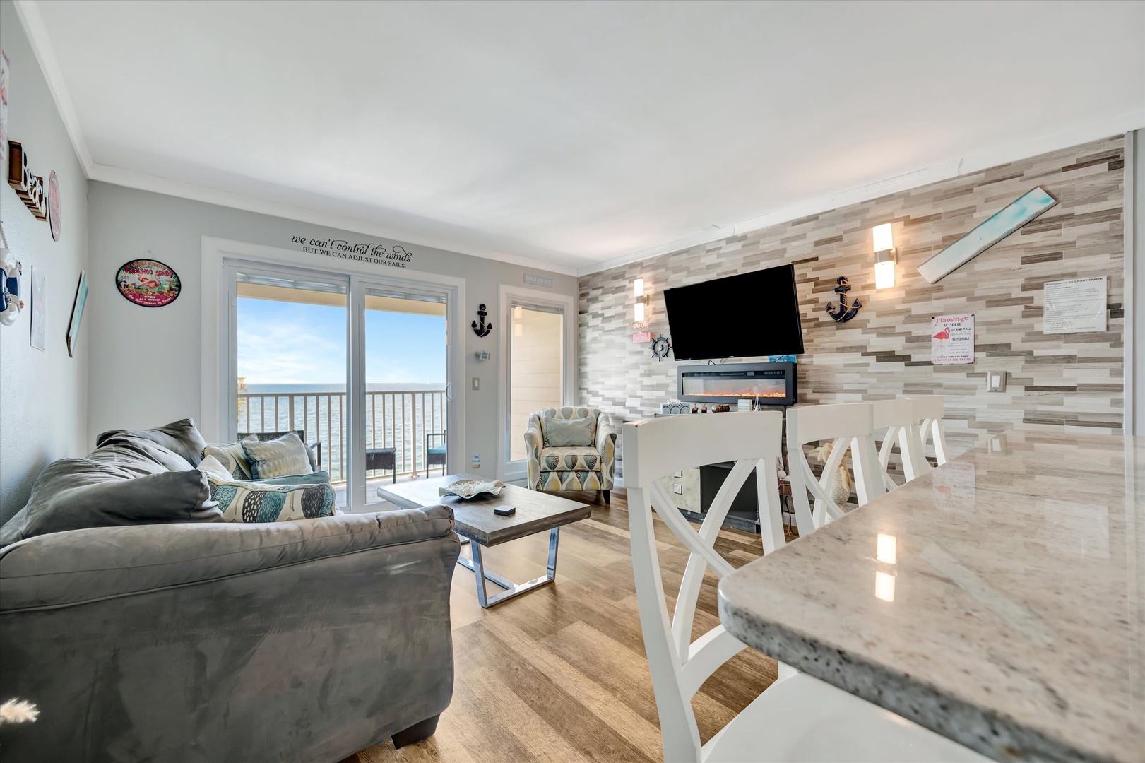 Unwind in your coastal retreat, where driftwood-style walls and nautical touches meet modern comfort. Watch the waves through expansive glass doors and soak in the oceanfront views from your private balcony.