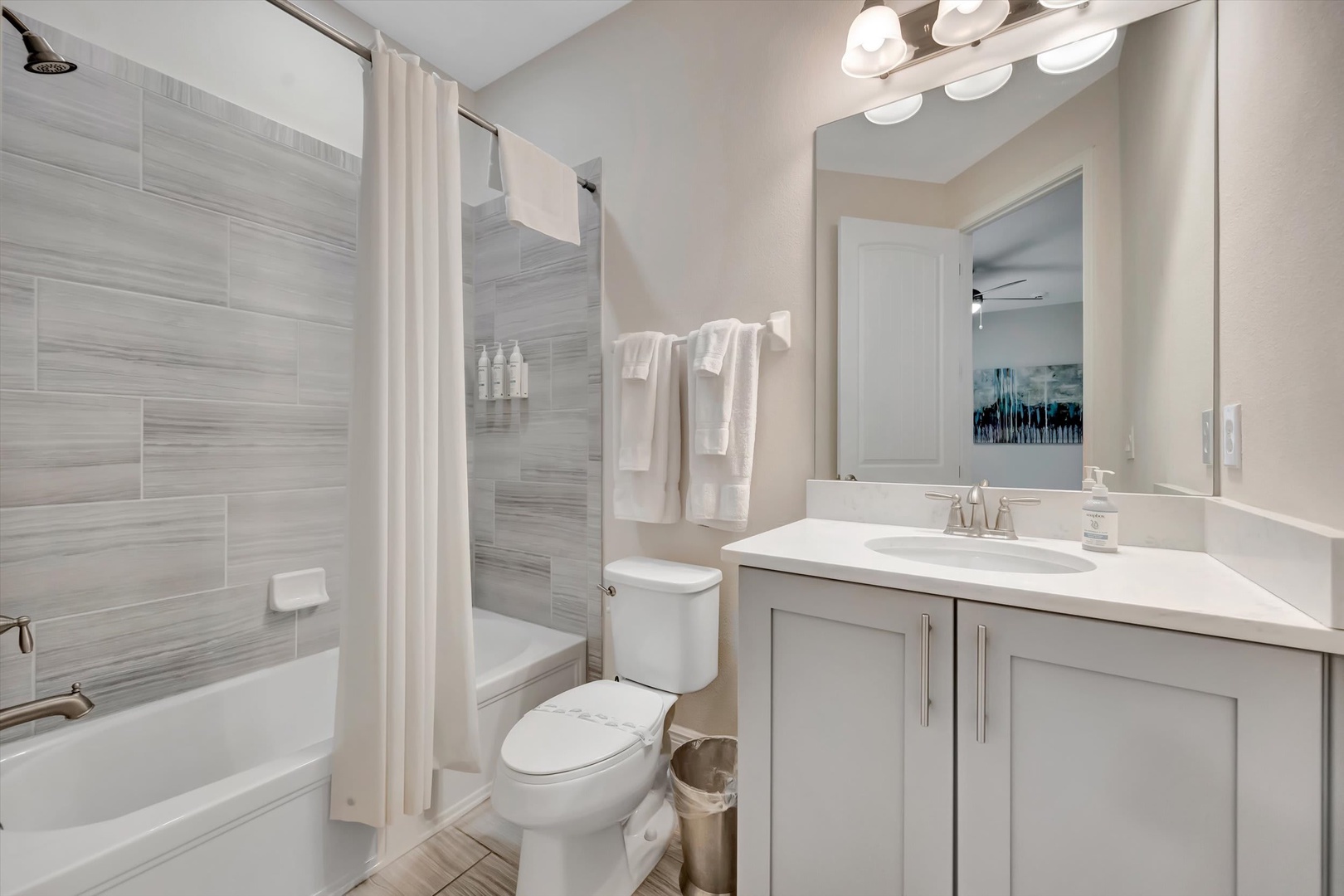 Step into your private spa-like retreat with sleek modern finishes, soft lighting, and plush towels waiting for you. The stylish tiled shower and pristine vanity make freshening up feel effortless and indulgent.