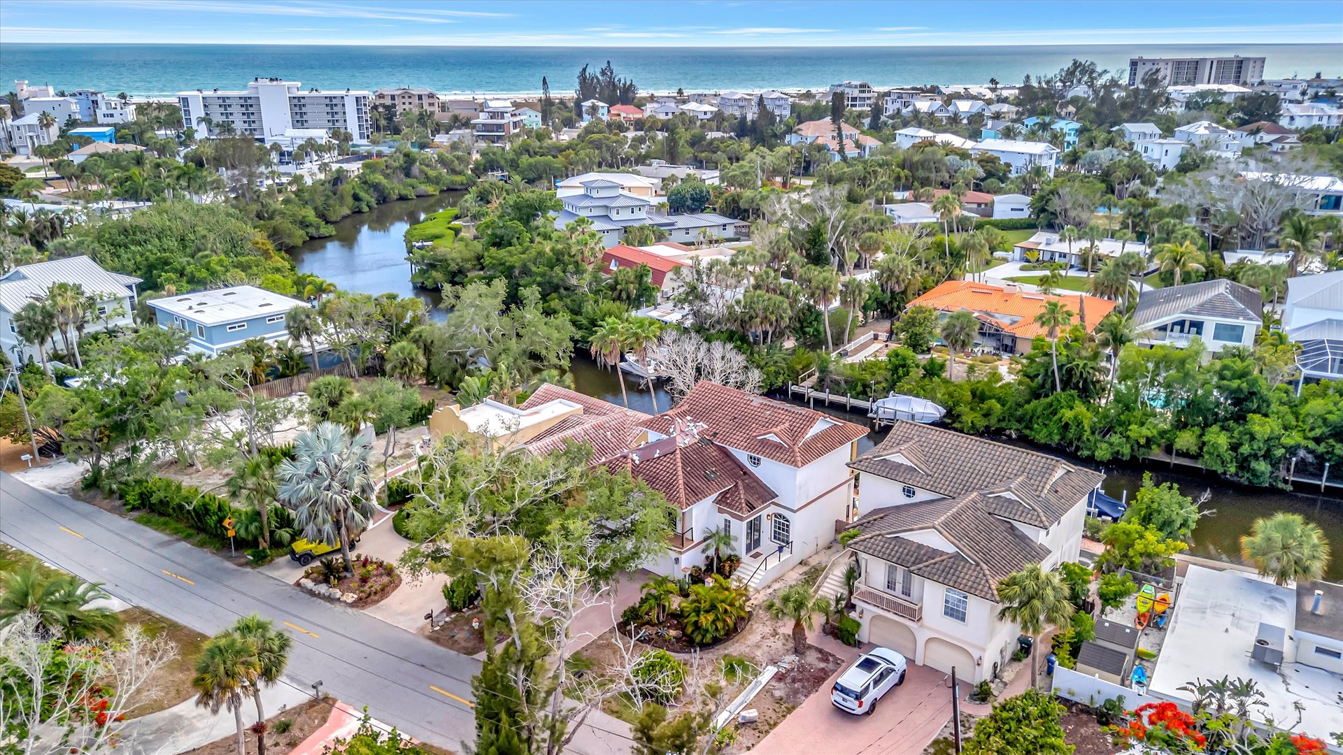 A stunning coastal neighborhood where lush tropical landscaping meets serene waterways and nearby beach access, creating a peaceful Florida paradise.