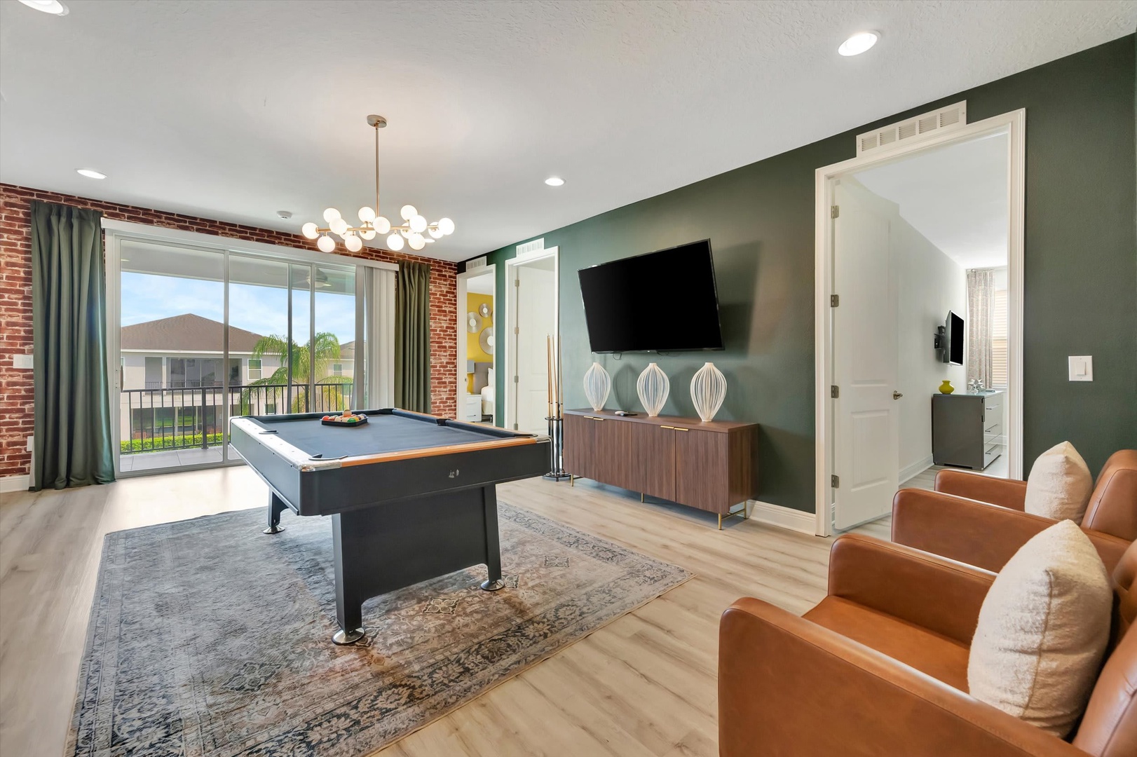 Gather around the pool table for friendly competition in your stylish game room, where rich sage walls and leather seating create the perfect atmosphere for memorable evenings with family and friends.