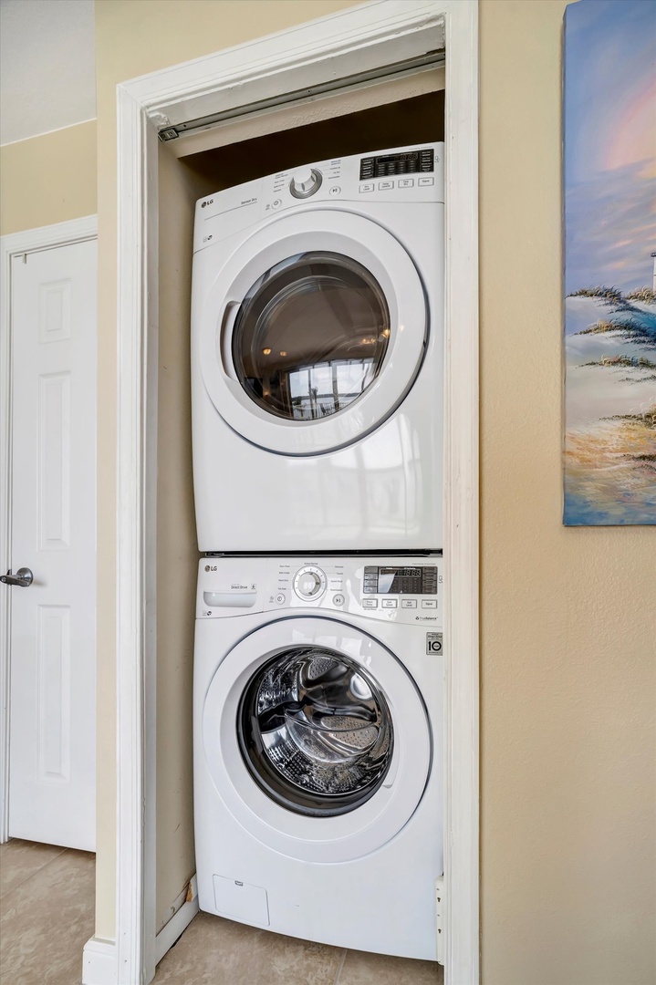 Your laundry essentials are neatly tucked away, with a full-size washer and dryer stacked in a closet for convenient access during your stay.