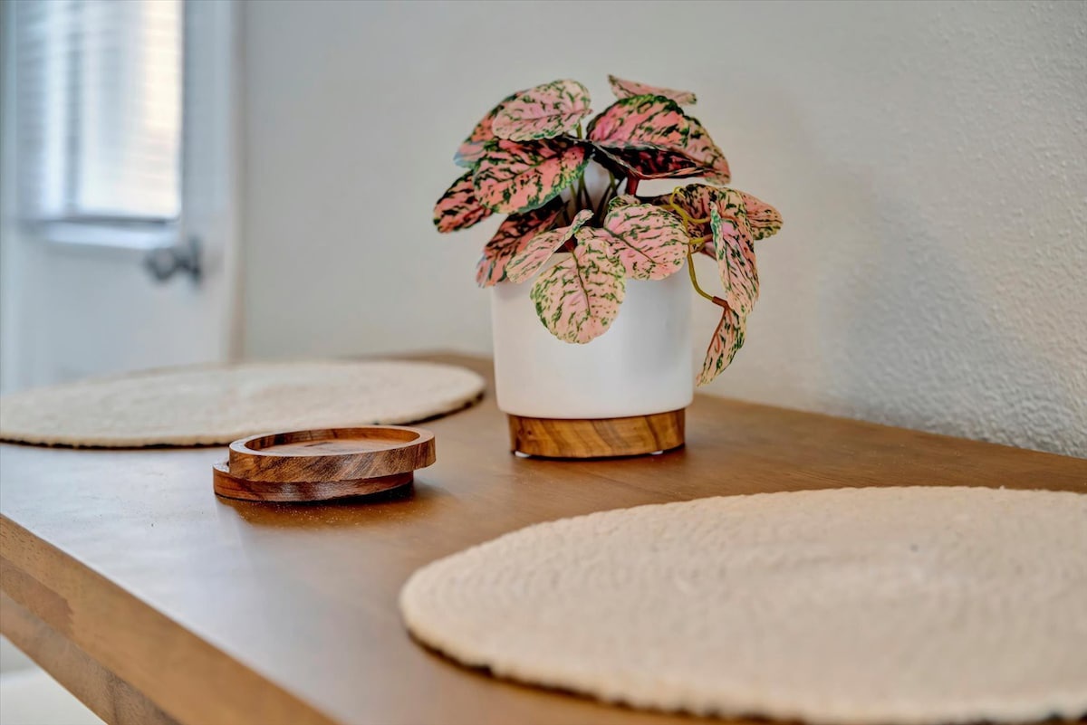Natural light and calming details create your peaceful retreat. Notice the pink-veined plant adding color and life to the thoughtfully designed space.