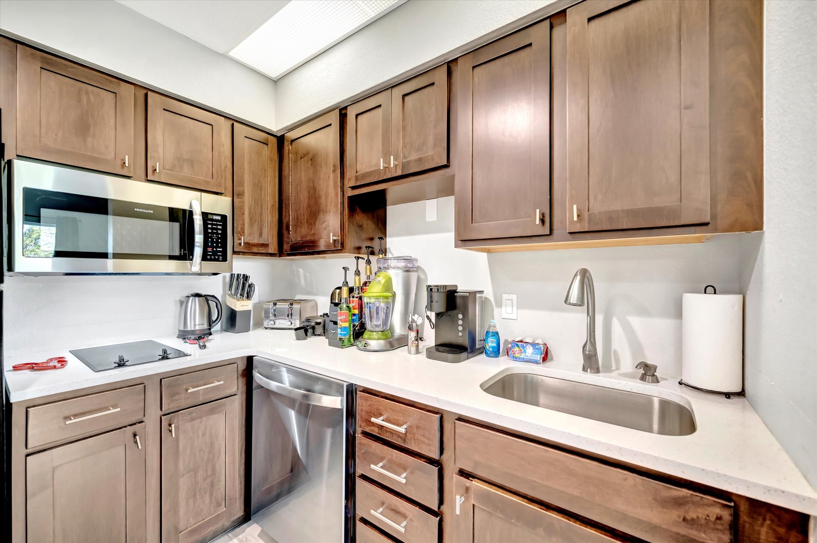 Step into your beautifully appointed kitchen, where rich wood cabinetry meets sleek stainless appliances. Everything you need to feel at home—from the smooth countertops to the modern fixtures—awaits your arrival.