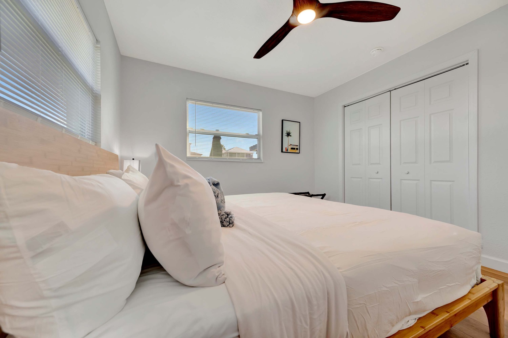 Sink into crisp white linens and let the ceiling fan's gentle breeze help you drift off. With plenty of closet space and a bright, airy feel, your bedroom becomes a restful retreat.