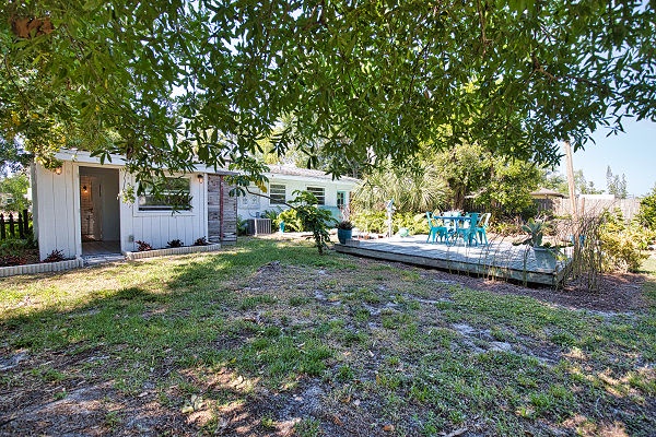 The property sits on spacious grounds with mature trees, lush greenery, and a peaceful atmosphere perfect for relaxing getaways.
