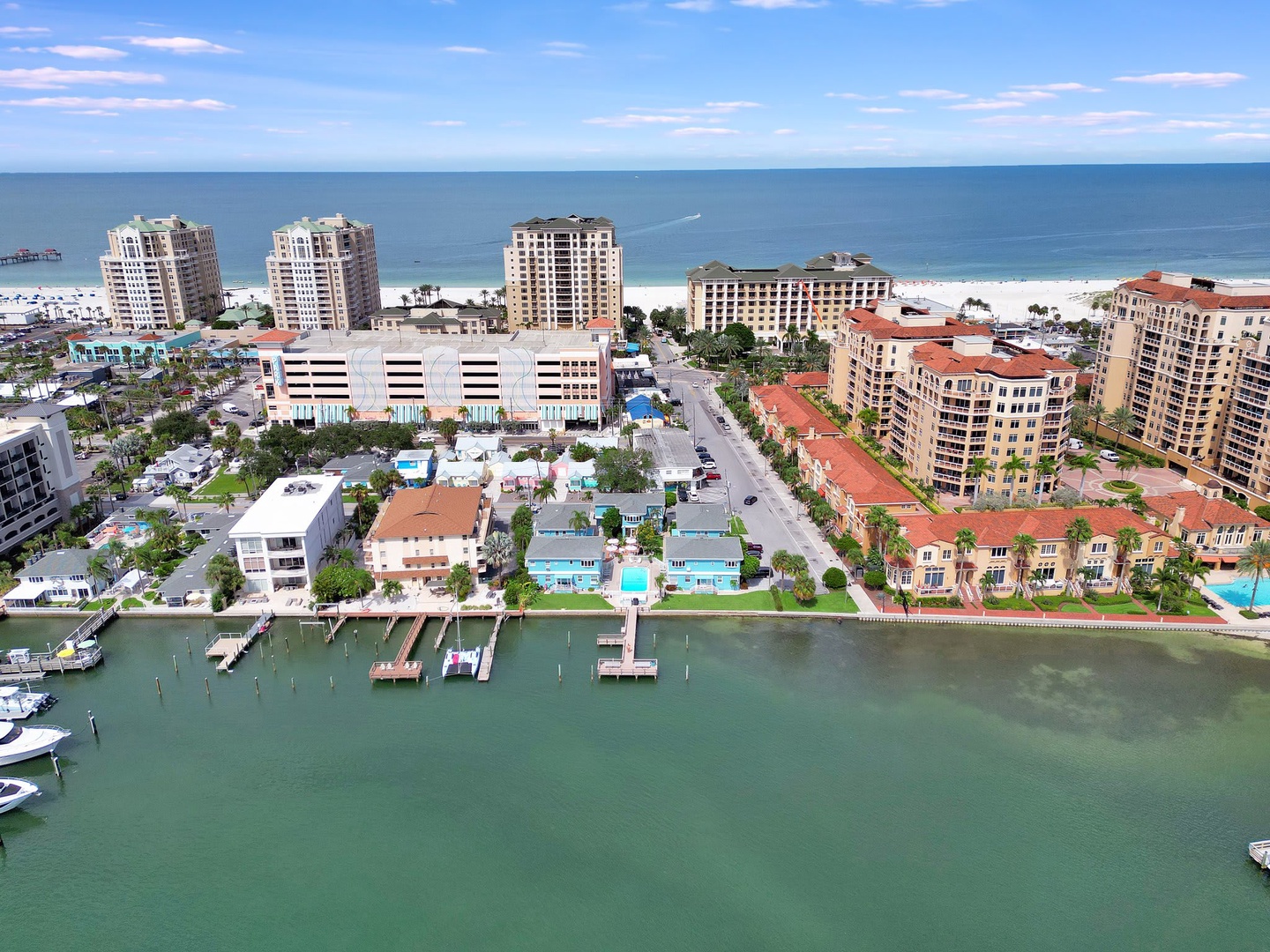 Aerial view of the beachfront property surrounded by waterfront access, sandy shores, and the Gulf of Mexico stretching along the horizon.