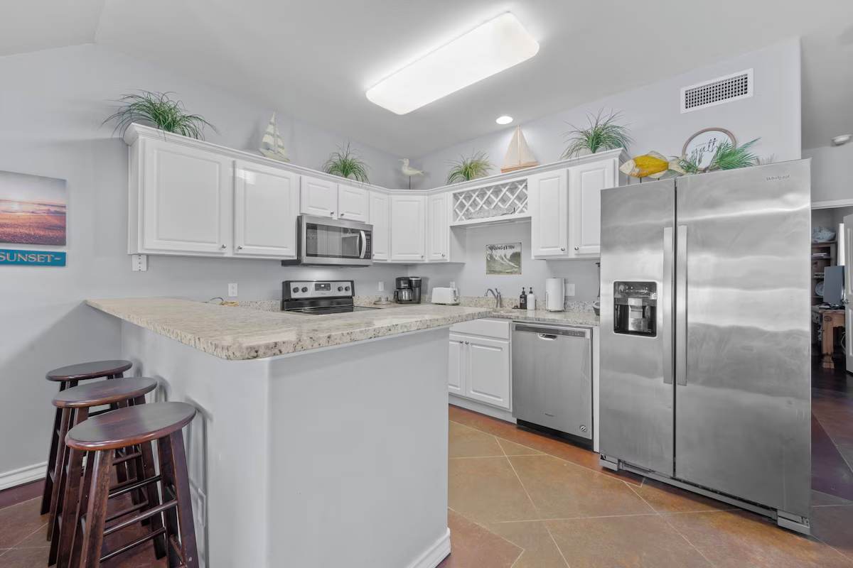 Your fully equipped kitchen awaits with granite countertops, stainless steel appliances, and a breakfast bar for casual meals. Everything you need to prepare your favorite dishes or enjoy morning coffee in this bright, welcoming space.
