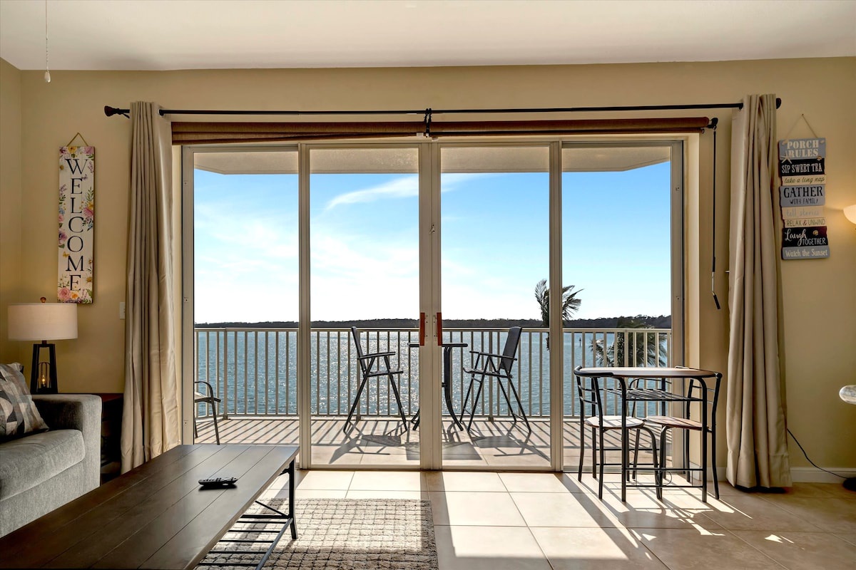 Step inside and let the sunlight pour through your private balcony doors, framing sparkling water views that stretch across the horizon. Your lakeside retreat awaits.