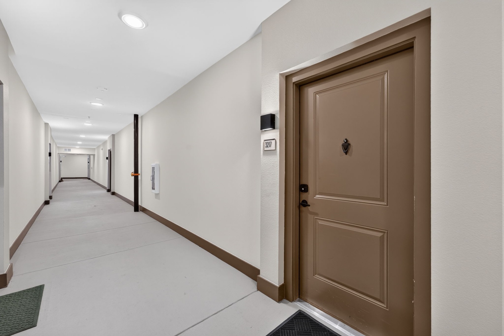 A bright, welcoming hallway leads you to your private entrance. Your space awaits behind this door, offering a clean and modern retreat after exploring the area.