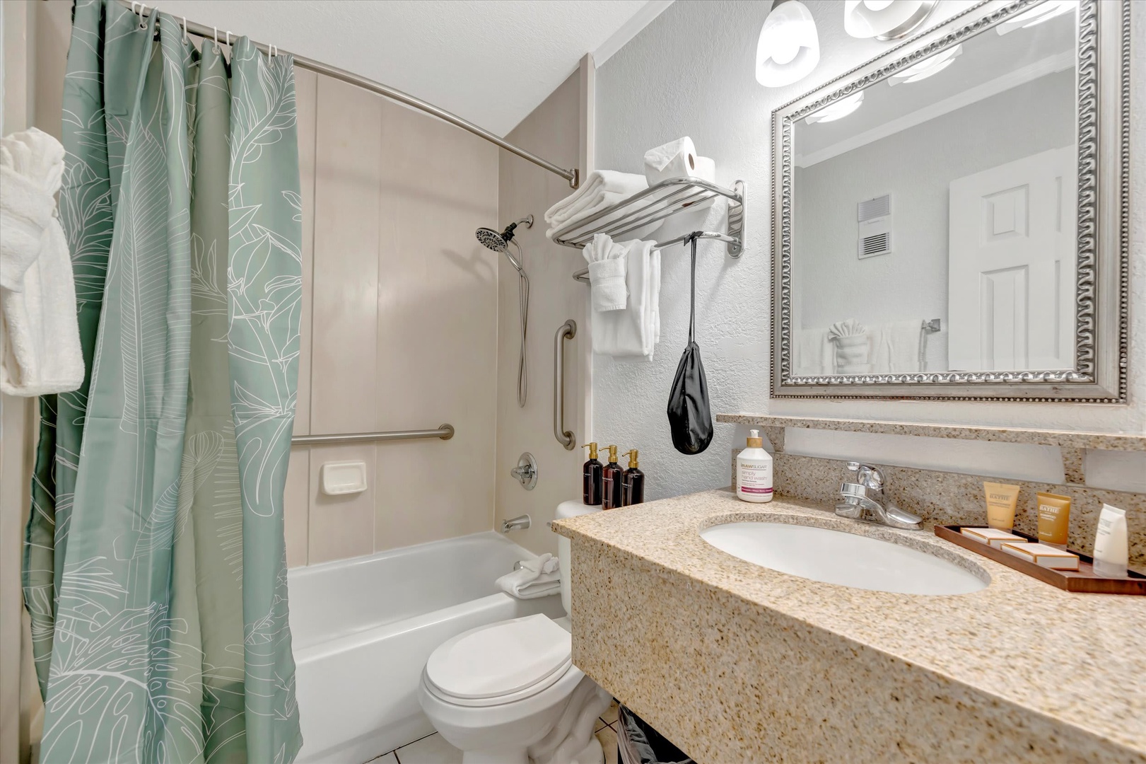 Freshen up in your private bathroom with its leaf-patterned shower curtain, granite counters, and fresh white towels waiting just for you.