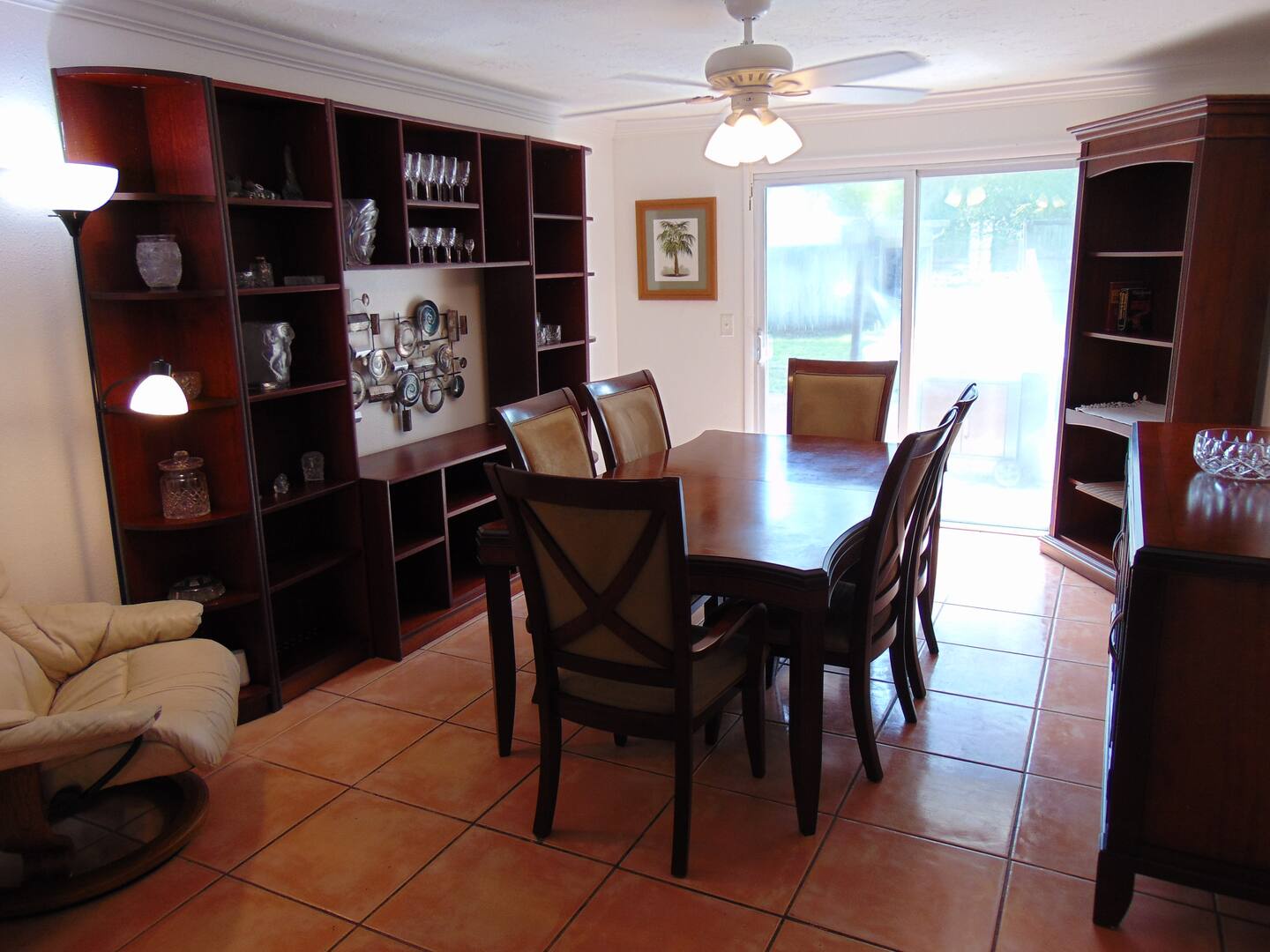 Gather around your dining table for memorable meals in this welcoming space. Rich wood furnishings and decorative shelving add character, while the sliding doors open to your private outdoor patio.