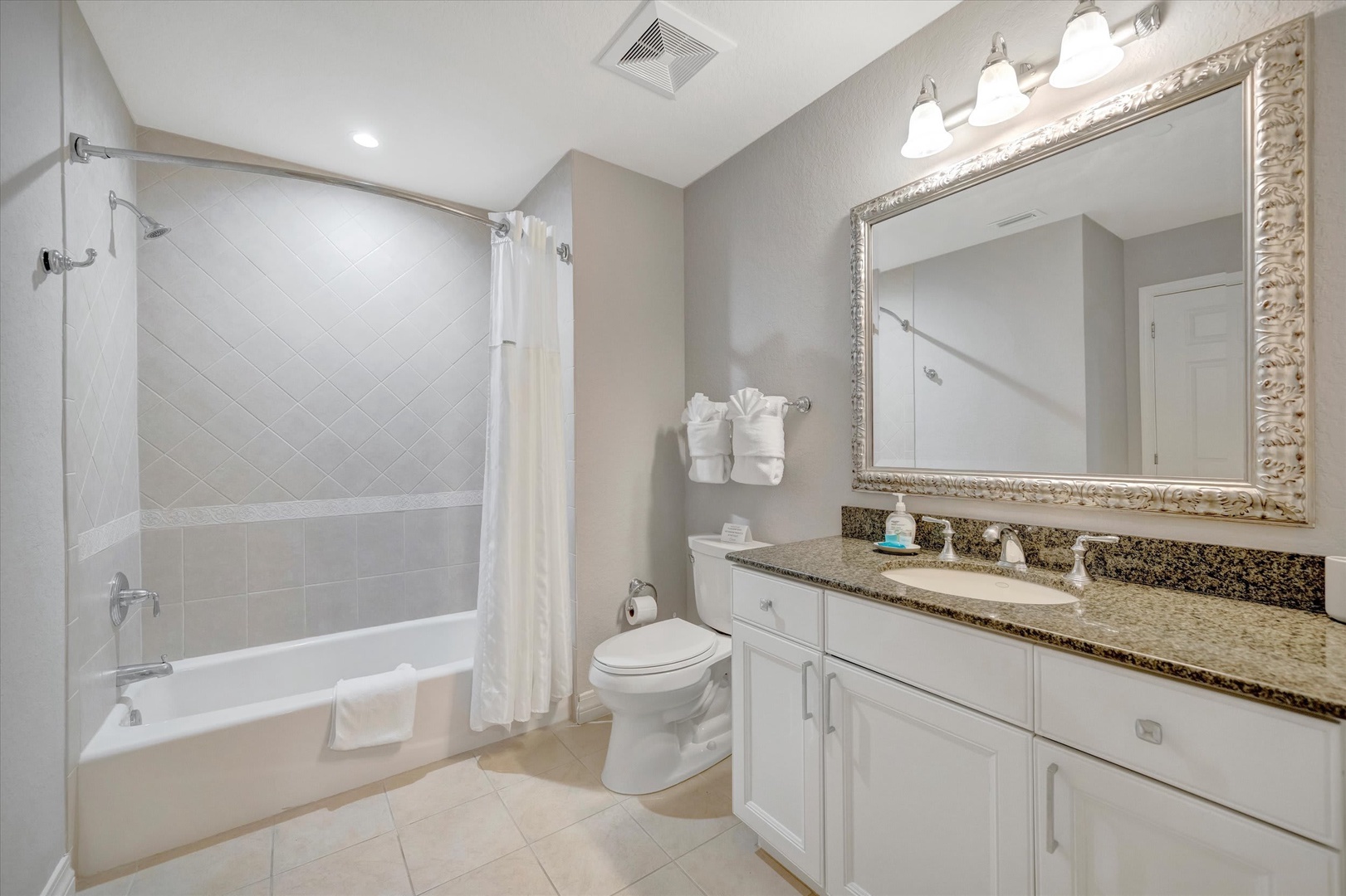 Step into your private spa-like retreat, where crisp white finishes and warm lighting set the tone for relaxation. The elegant vanity and soaking tub invite you to unwind in style and comfort.