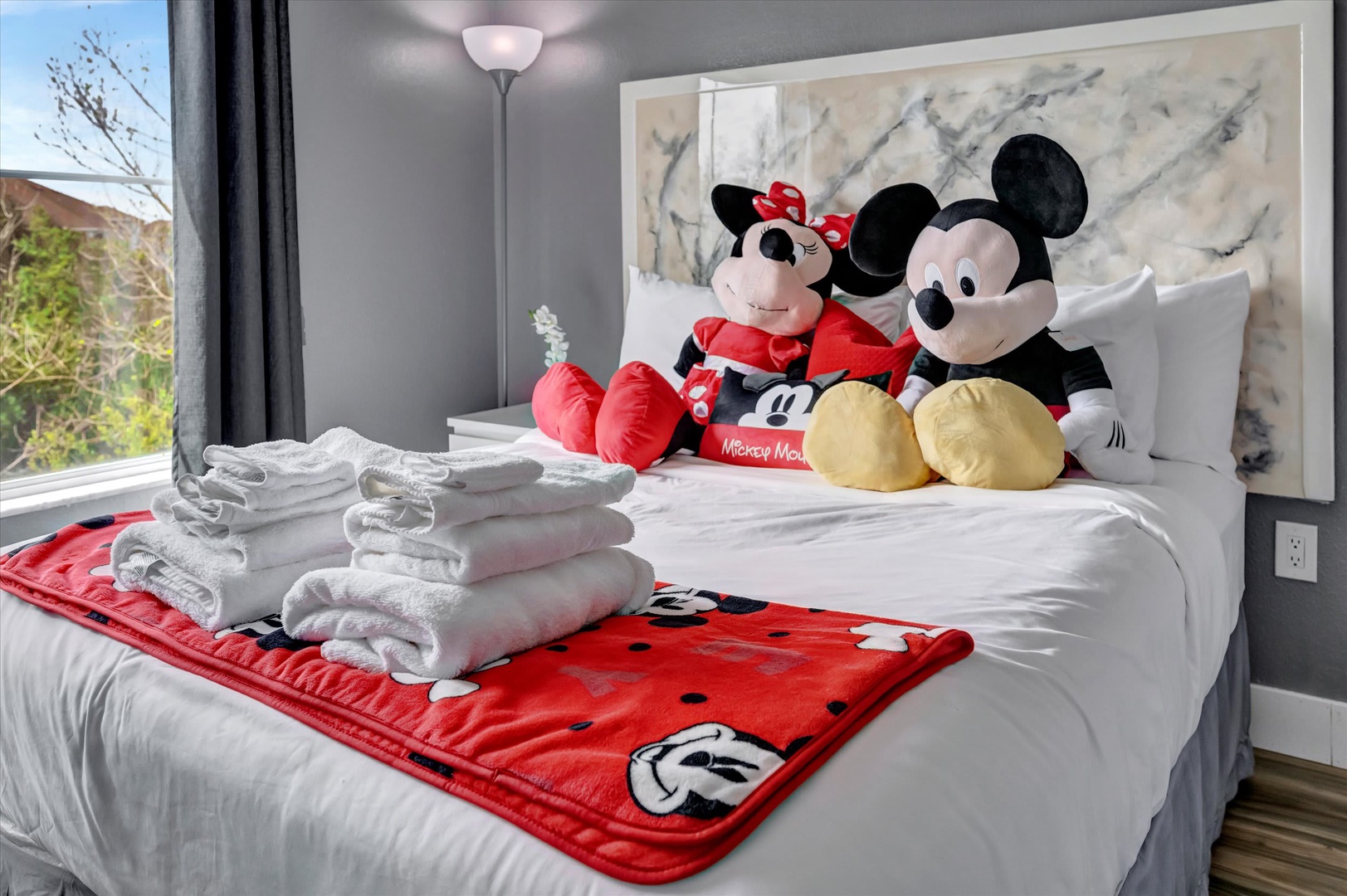 Step into a bright, family-friendly bedroom where playful touches await. Soft natural light fills the space, and Mickey and Minnie are ready to welcome your little ones for a magical stay.
