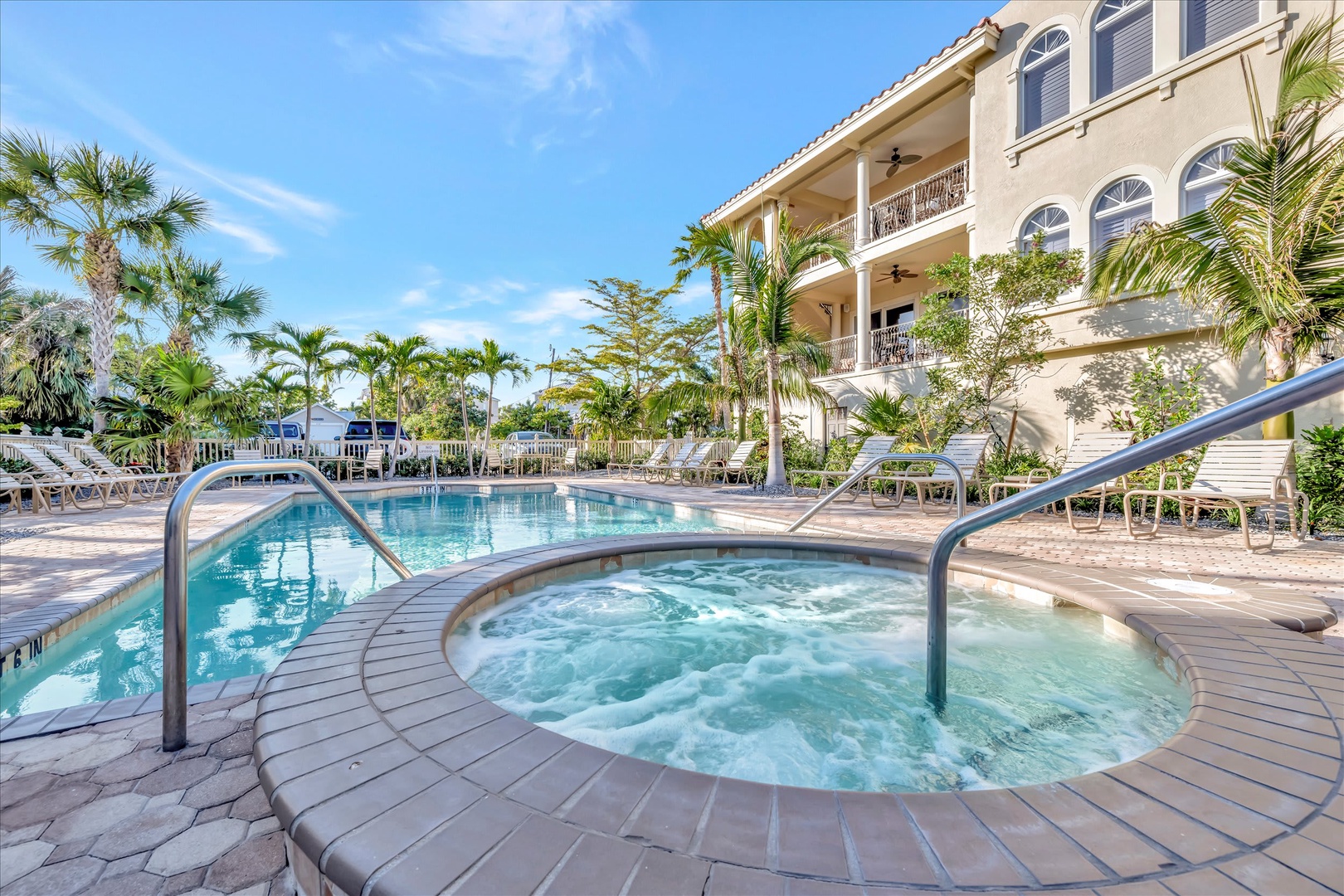 Soak in the bubbling hot tub or take a refreshing dip in the sparkling pool, surrounded by swaying palms and tropical sunshine—your perfect outdoor escape awaits.