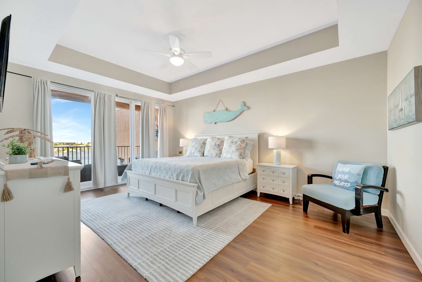 Drift off to sleep in this serene coastal-themed bedroom, where soft linens and gentle sea breezes from your private balcony create the perfect retreat after a day of adventure.