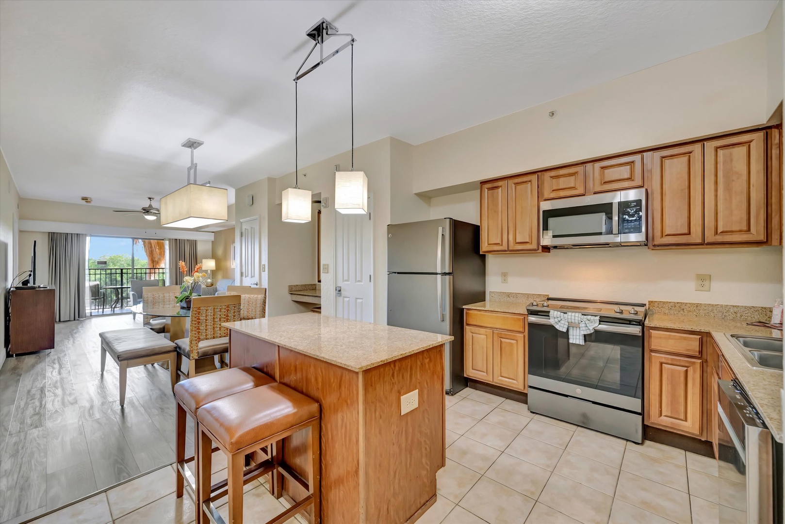 Bright, open-concept living with a kitchen island perfect for your morning coffee and quick bites. The space flows beautifully from cooking to dining to relaxing, with a sunny balcony inviting you to step outside.