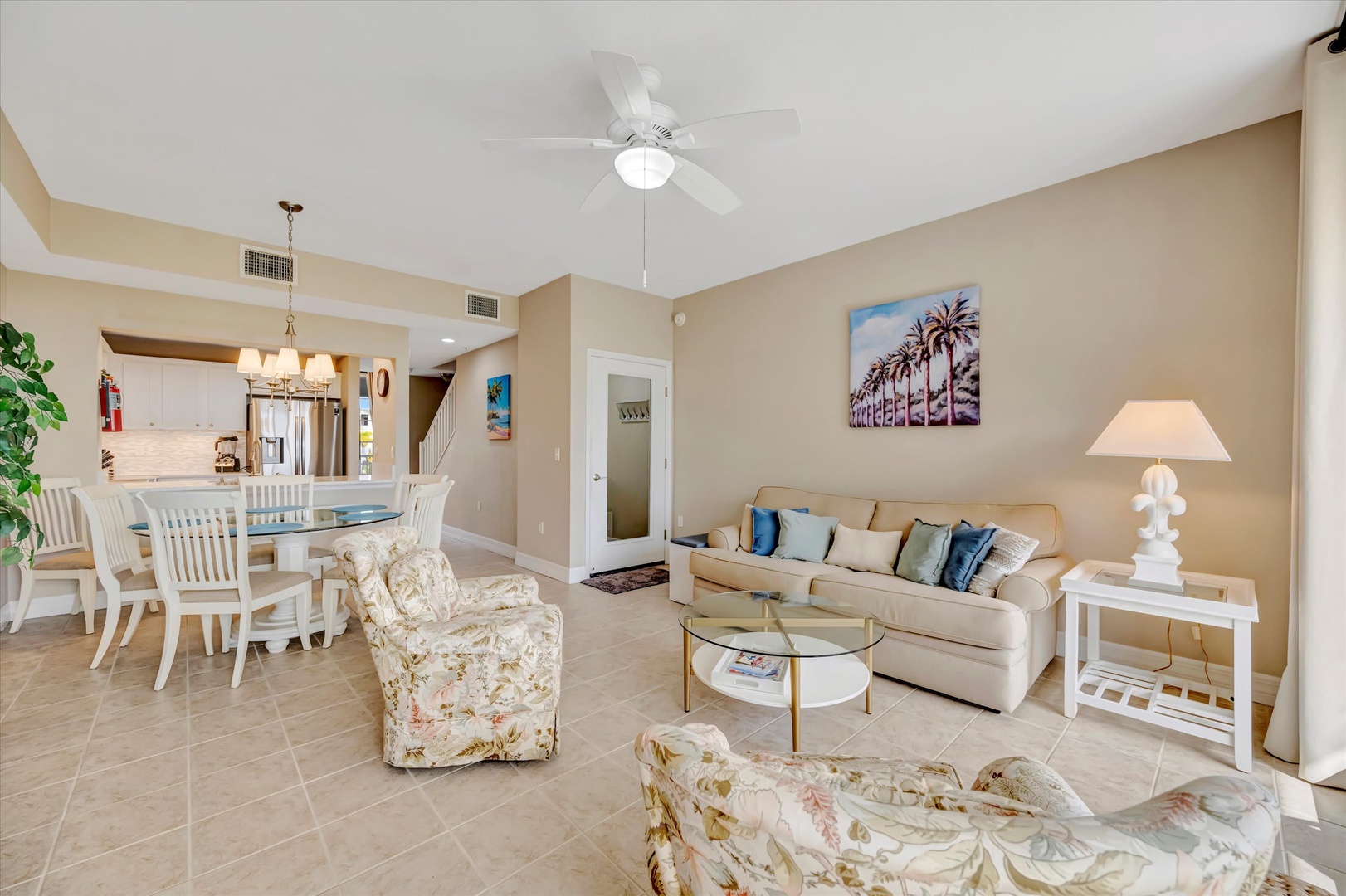 Relax in your bright, open-concept living space with comfortable seating, a cozy dining area, and cool tile floors—perfect for unwinding after a day of beach adventures.