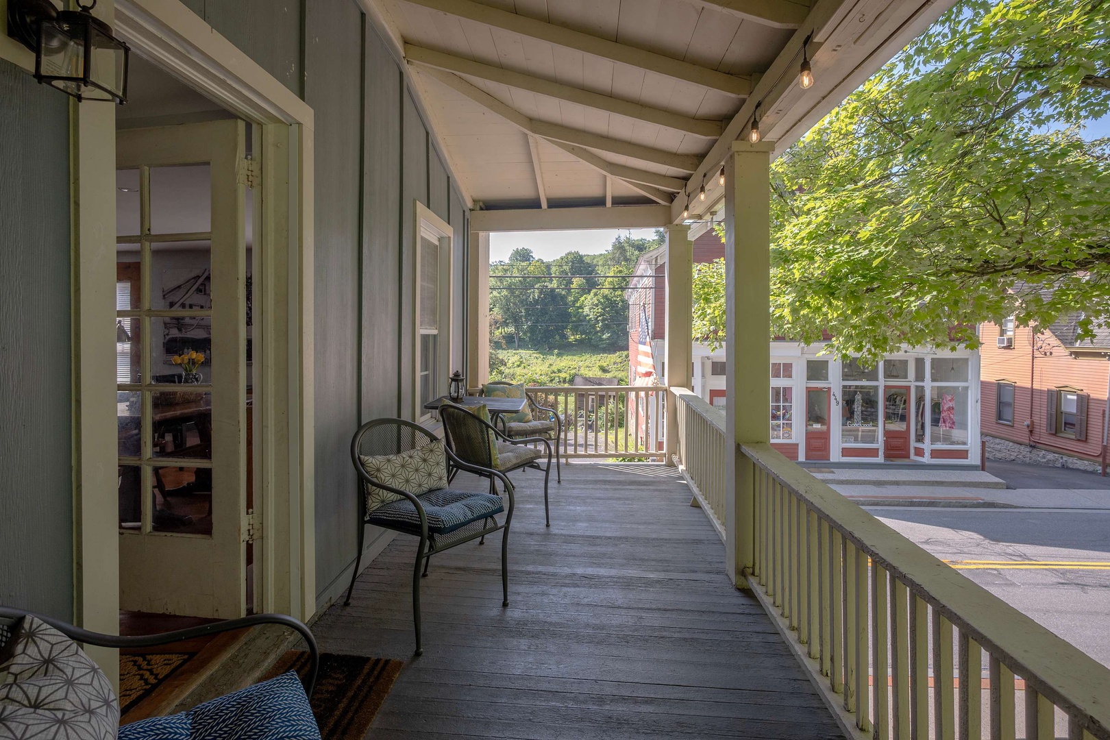 Relax on your private covered porch with street-side seating, perfect for morning coffee or watching the charming neighborhood stroll by.