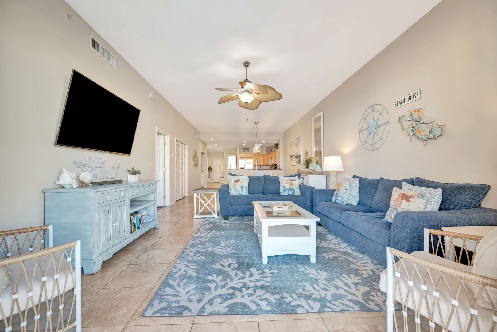 Sink into plush coastal-style seating and unwind with your favorite shows in this bright, airy living room. The soothing beach-themed decor and open layout create the perfect spot for family gatherings or quiet relaxation.