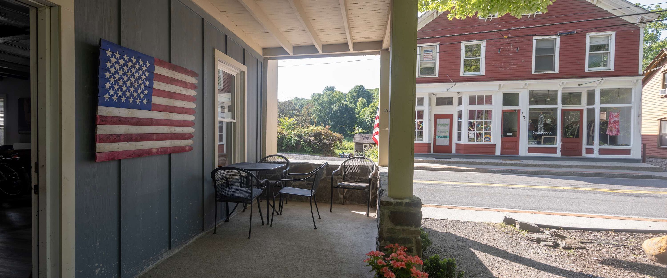 The covered front porch frames charming street views of the neighborhood, offering a peaceful spot to enjoy your morning coffee while watching the quiet town come to life.