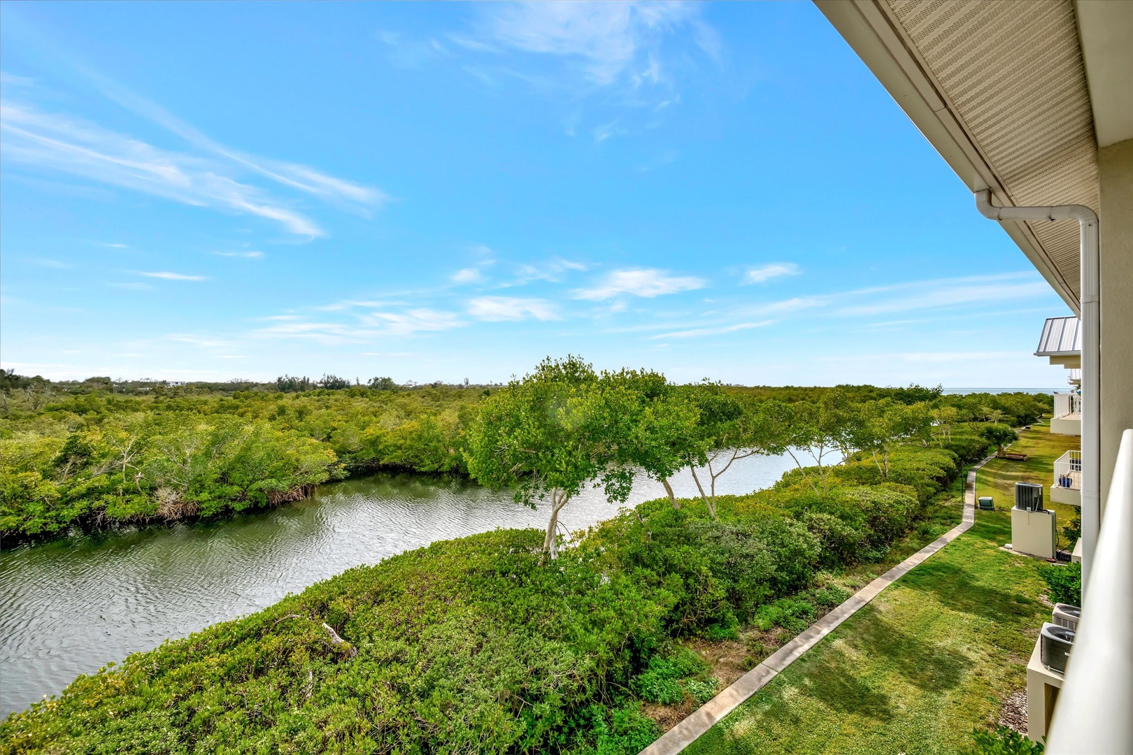 Wake up to sweeping views of tranquil waterways and lush greenery right from your own balcony. The peaceful river and verdant landscape create a serene natural escape for your stay.