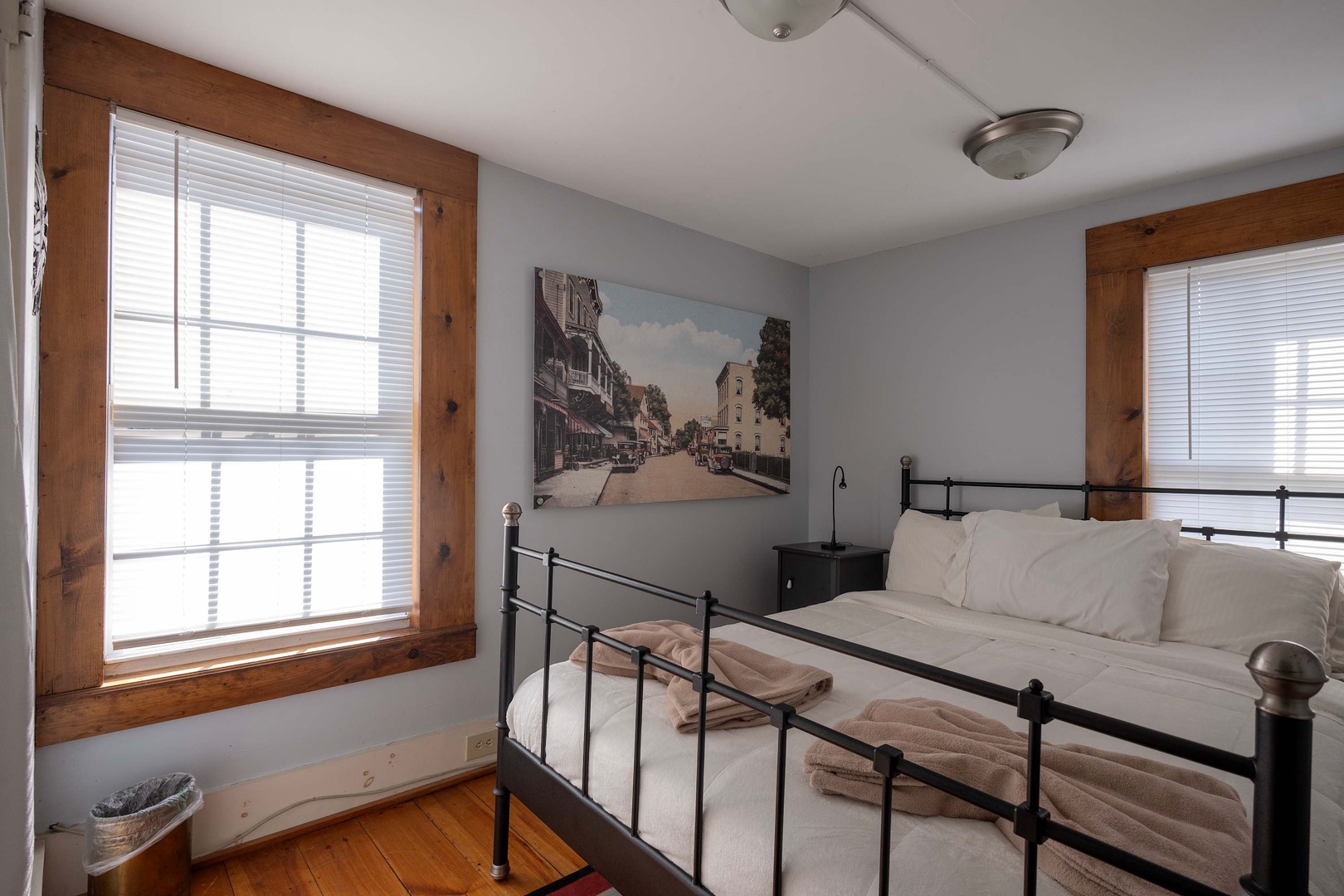 Wake up in a bright, serene space with crisp linens and charming wood-framed windows that let the daylight pour in—your peaceful retreat awaits.