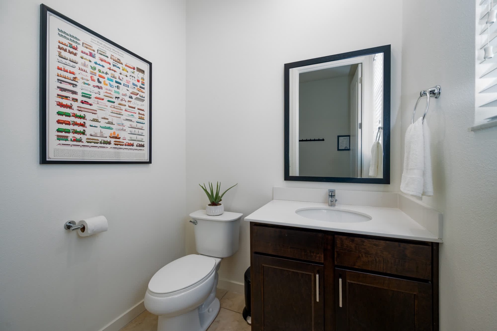Freshen up in this clean, modern bathroom with bright lighting, a stylish vanity, and all the essentials you'll need during your stay.