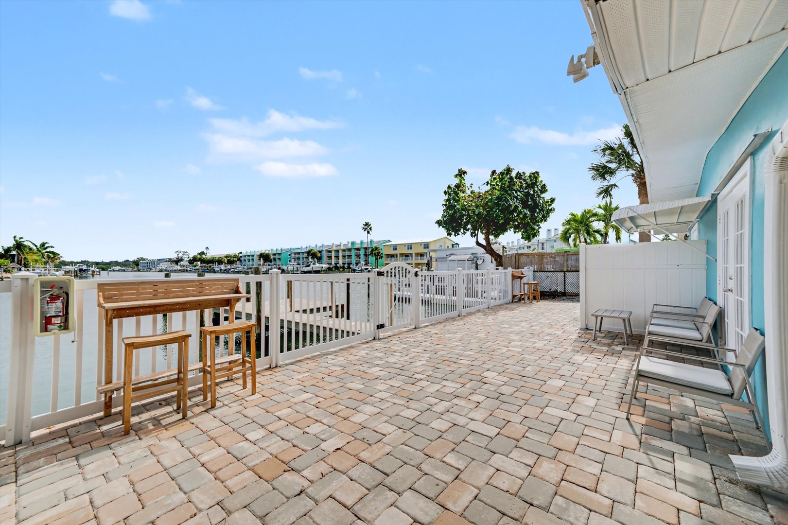 Spacious rooftop terrace with brick pavers, offering tropical surroundings and ample space to relax under sunny skies, perfect for morning coffee or sunset gatherings.