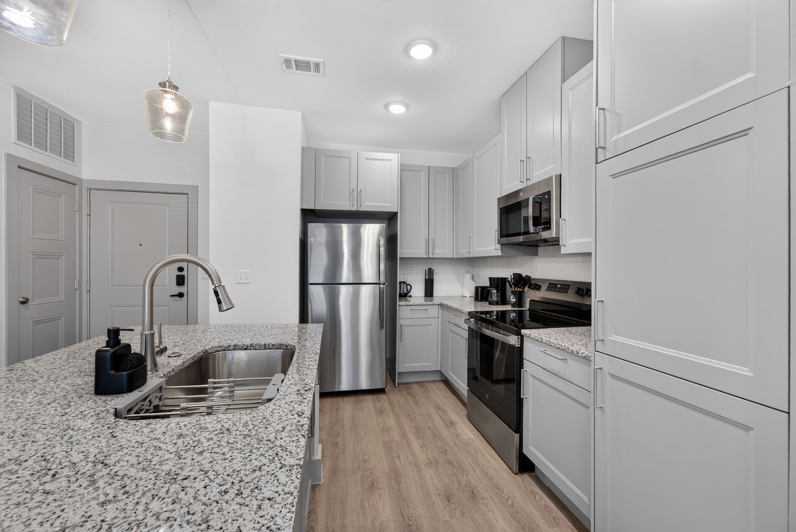 Your modern, fully-equipped kitchen awaits, complete with stainless steel appliances, granite countertops, and everything you need to whip up a delicious meal during your stay.