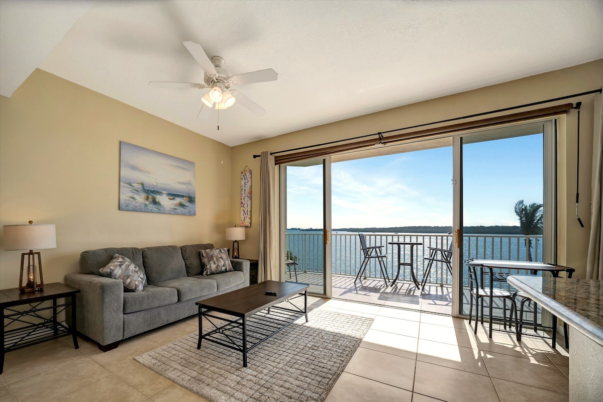 Relax in your bright, airy living space where large glass doors frame stunning waterfront views. Step out to your private balcony and soak in the peaceful bay scenery whenever you like.
