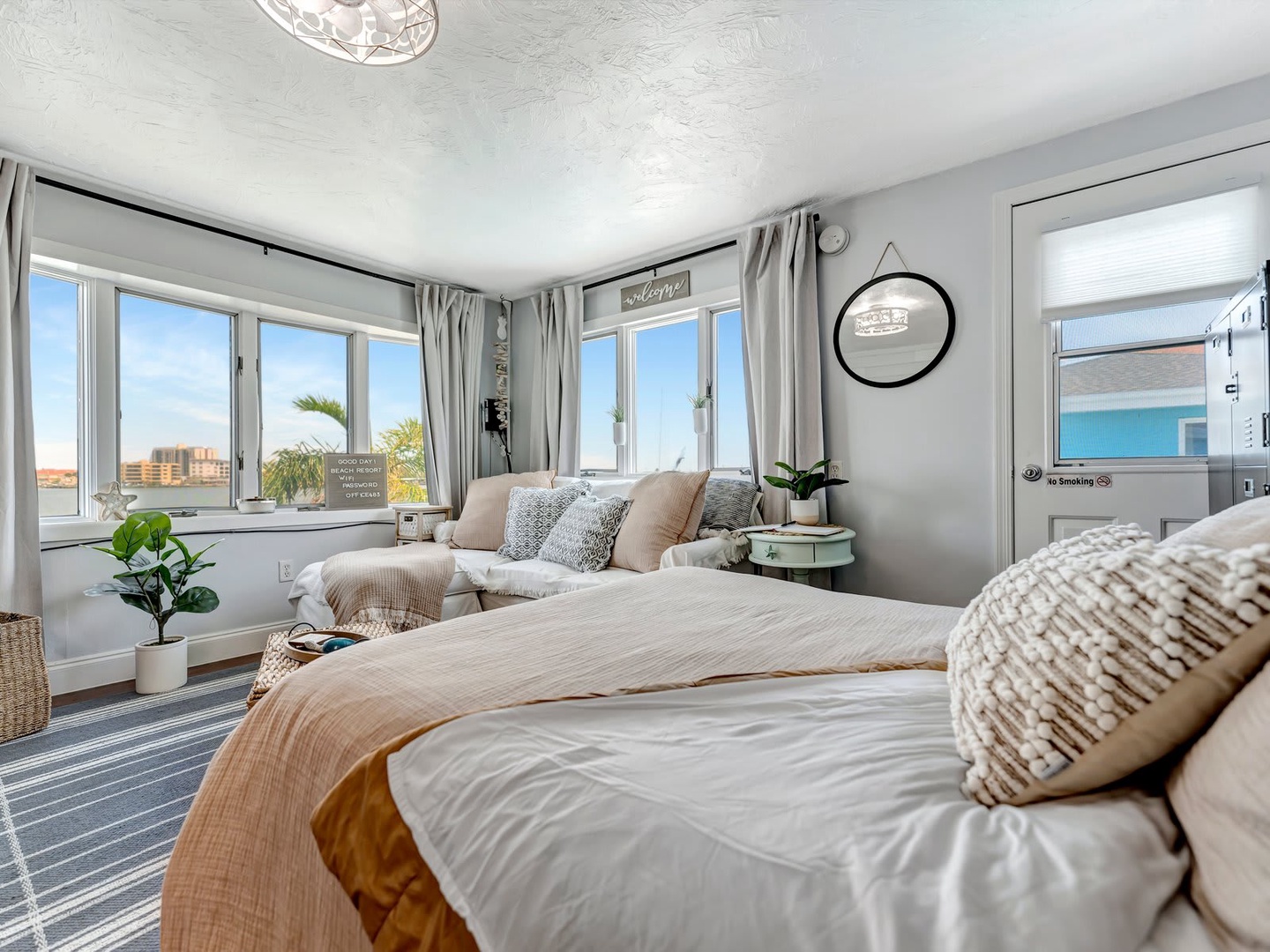 Wake to soft light streaming through your windows, with water views framing your coastal retreat. This calming bedroom invites you to unwind in plush linens and neutral tones.
