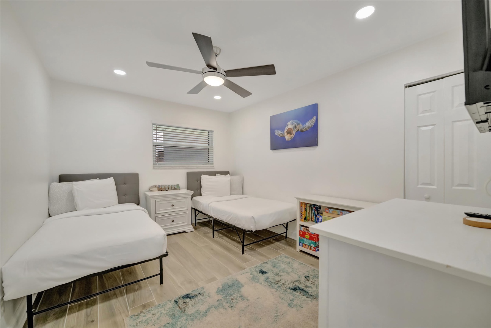 Rest easy in your bright, thoughtfully designed bedroom with two comfortable beds and coastal touches that invite relaxation after a day of adventure.