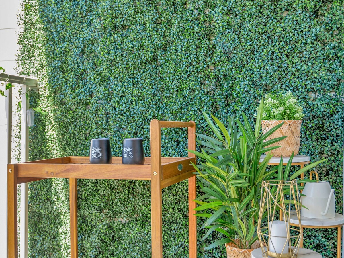 Relax in your own green sanctuary, where lush living walls and natural wood accents create a serene escape that brings the outdoors right to your door.
