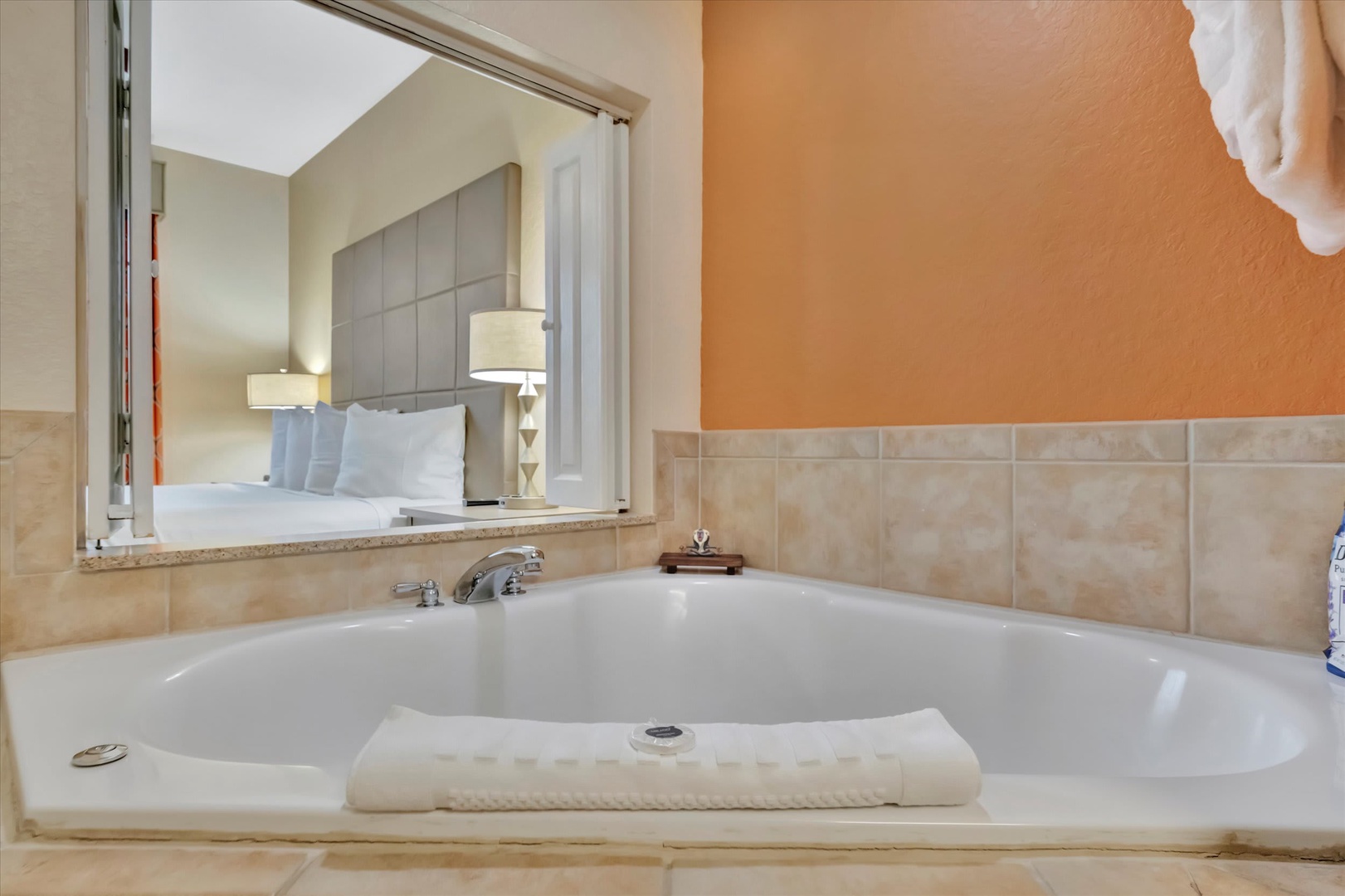 Unwind in your private soaking tub with a view straight through to the plush bedroom—a seamless space designed for total relaxation.