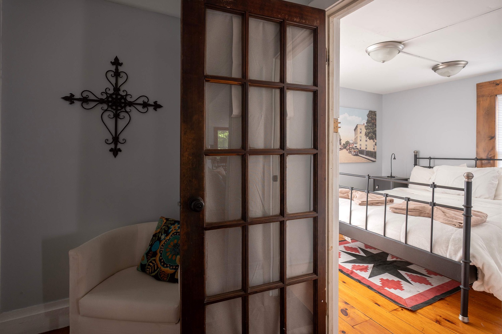 Step into your inviting bedroom retreat, where warm wooden floors and thoughtful touches create a peaceful sanctuary. The elegant door and decorative details add character, making this space feel like your own private haven.