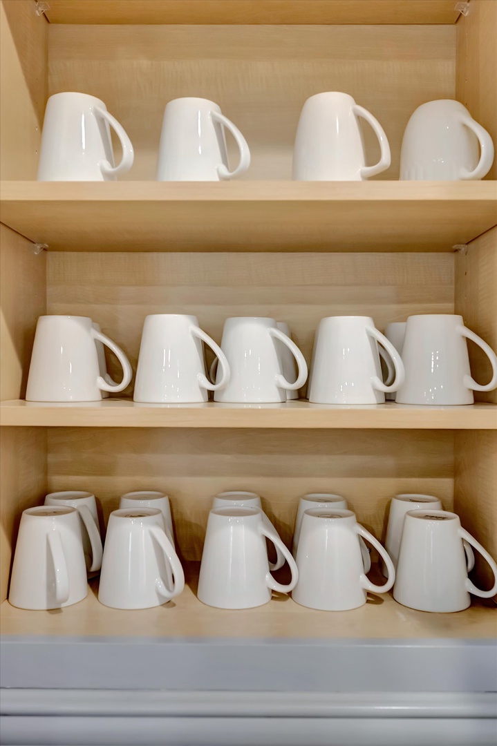Your morning coffee routine is simplified with plenty of pristine white mugs neatly organized and ready for use.
