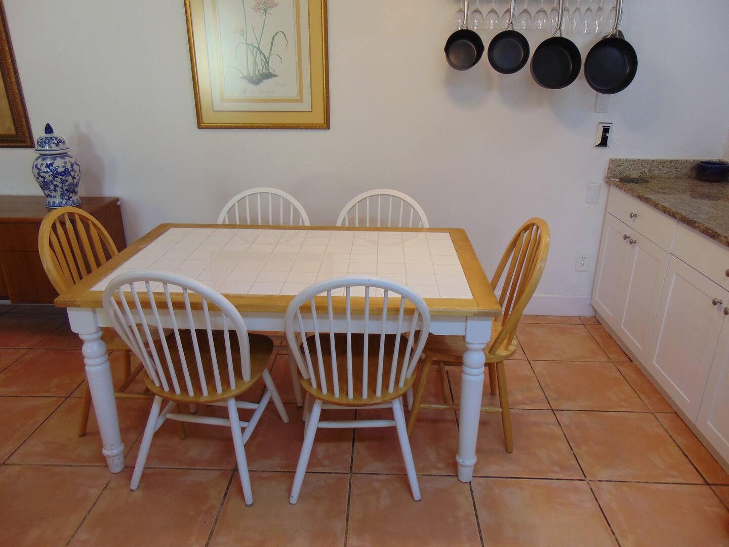 Gather around this inviting dining table for your meals, whether it's a leisurely breakfast or evening dinner. The fully equipped kitchen provides everything you need to prepare delicious home-cooked favorites.
