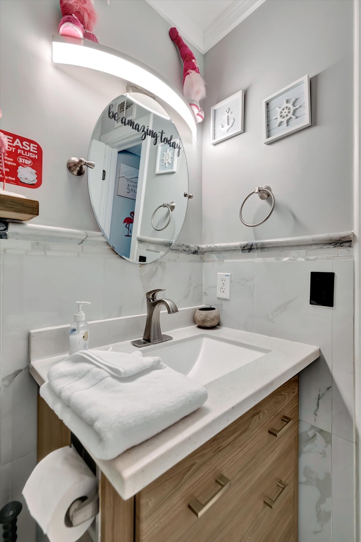 Step into your cheerful private bathroom, where fluffy towels and playful flamingo decor add a splash of fun to your daily routine.