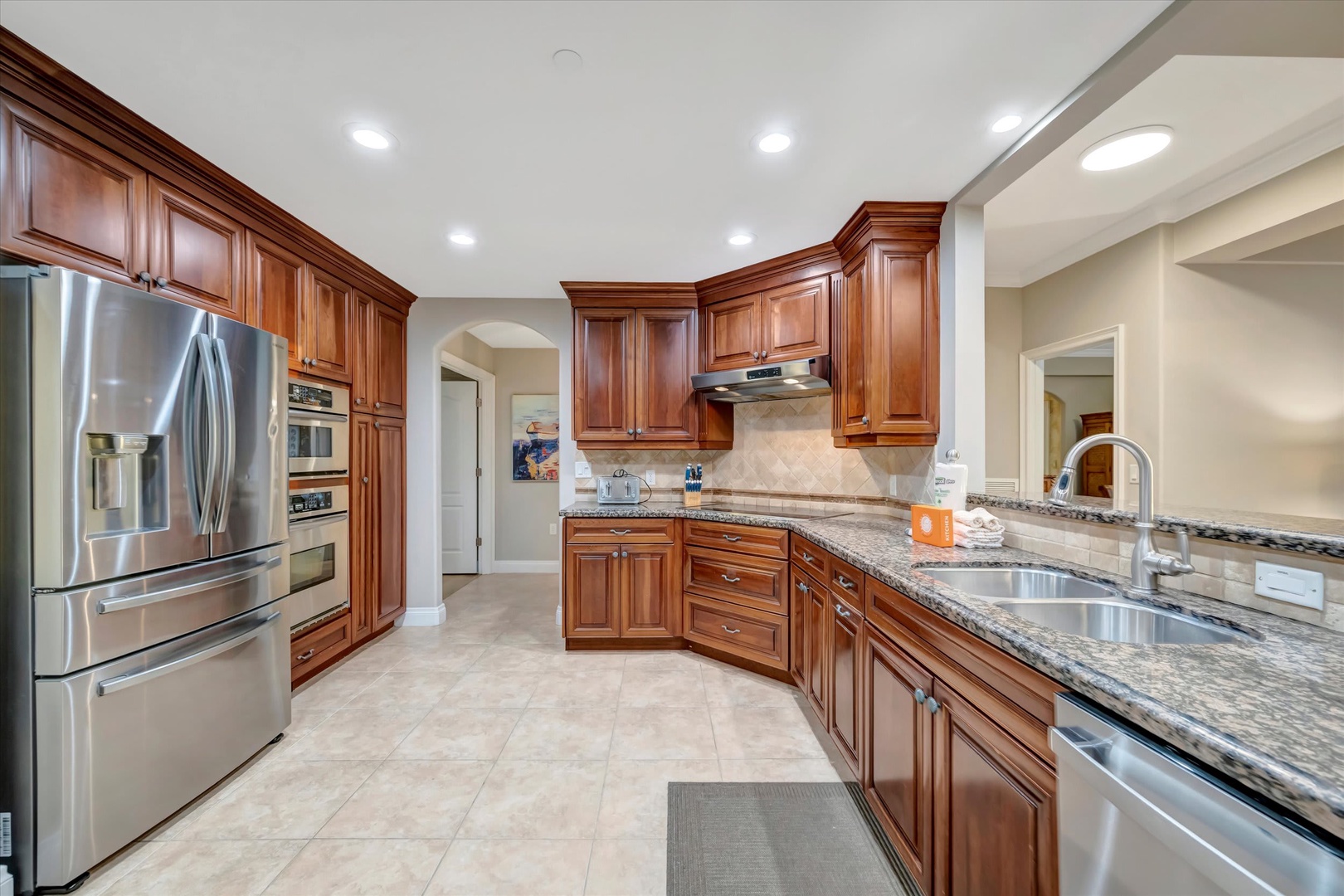 A beautifully appointed gourmet kitchen awaits you with rich wood cabinetry, gleaming granite countertops, and stainless steel appliances. The spacious layout gives you plenty of room to prepare meals and gather with family.