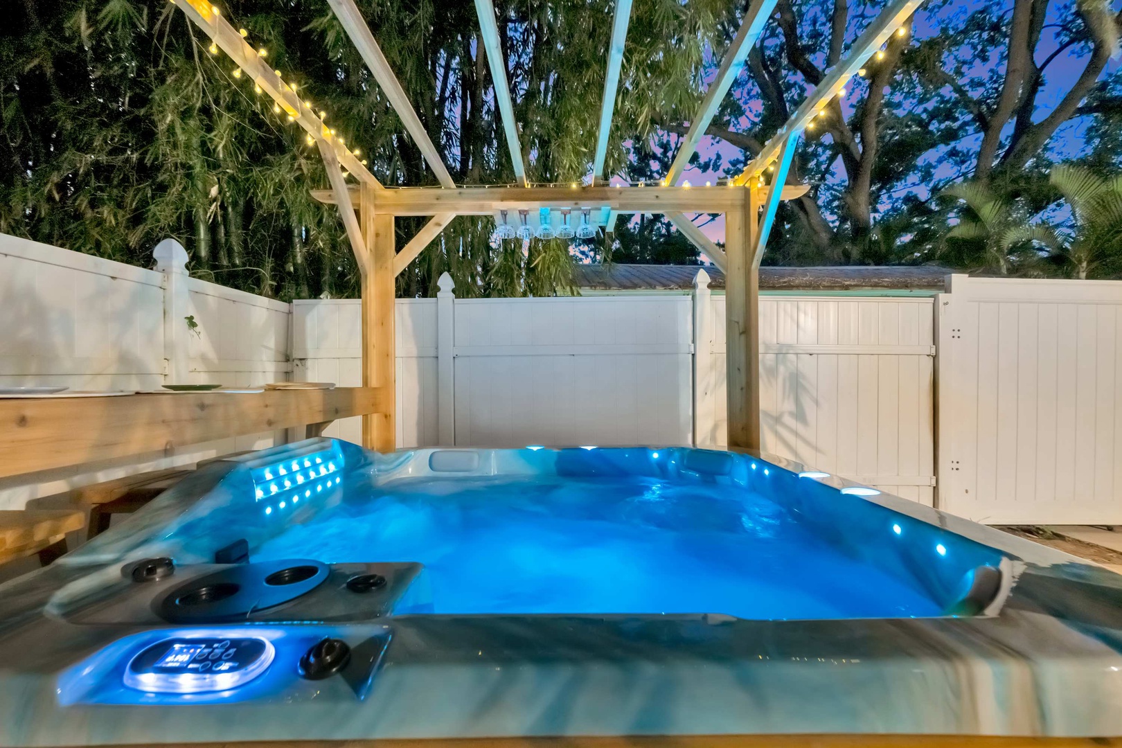 Slip into your private hot tub under twinkling lights and swaying palms. This cozy outdoor retreat invites you to unwind after a day of adventure.