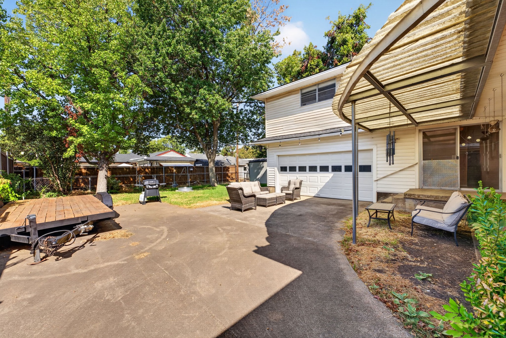 A shaded outdoor space with lounge seating and a covered patio—ideal for relaxing under the trees after exploring the area.