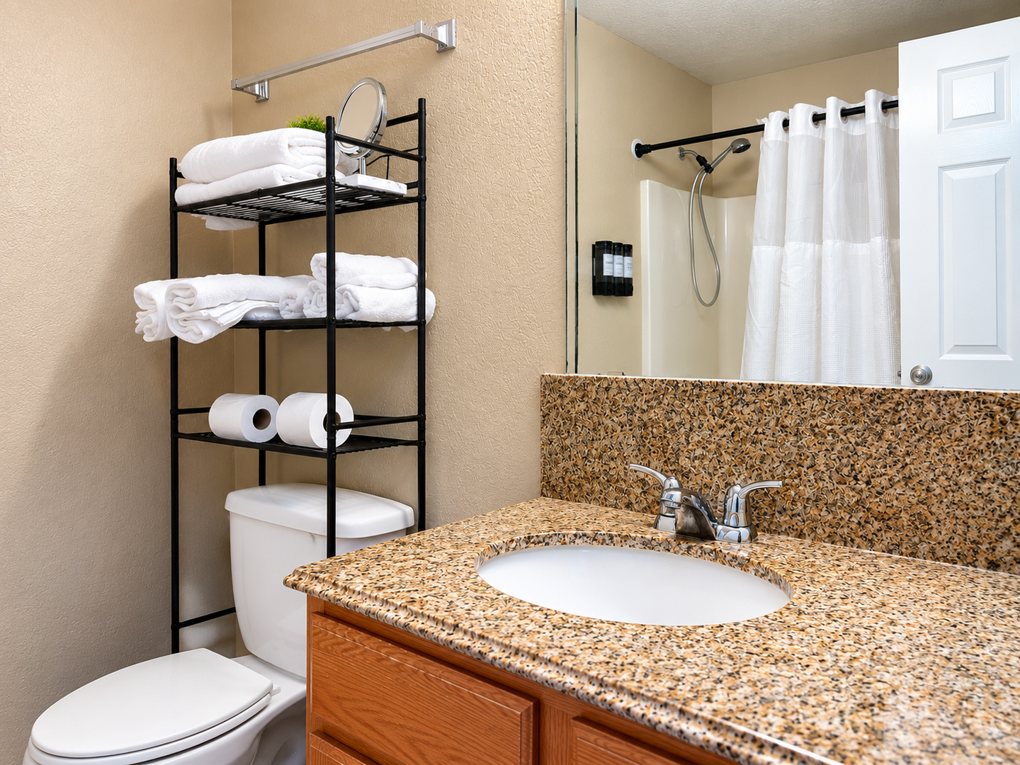 Freshen up in your private bathroom, complete with granite countertops, a generous walk-in shower, and fluffy towels stacked within easy reach for your convenience.