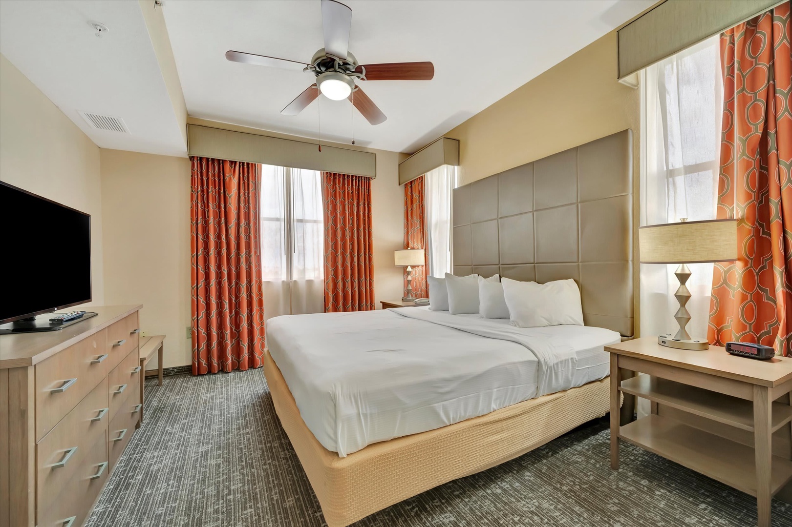 Sink into plush bedding in your peaceful bedroom, where soft lighting and warm tones create the perfect retreat after a day of adventure.