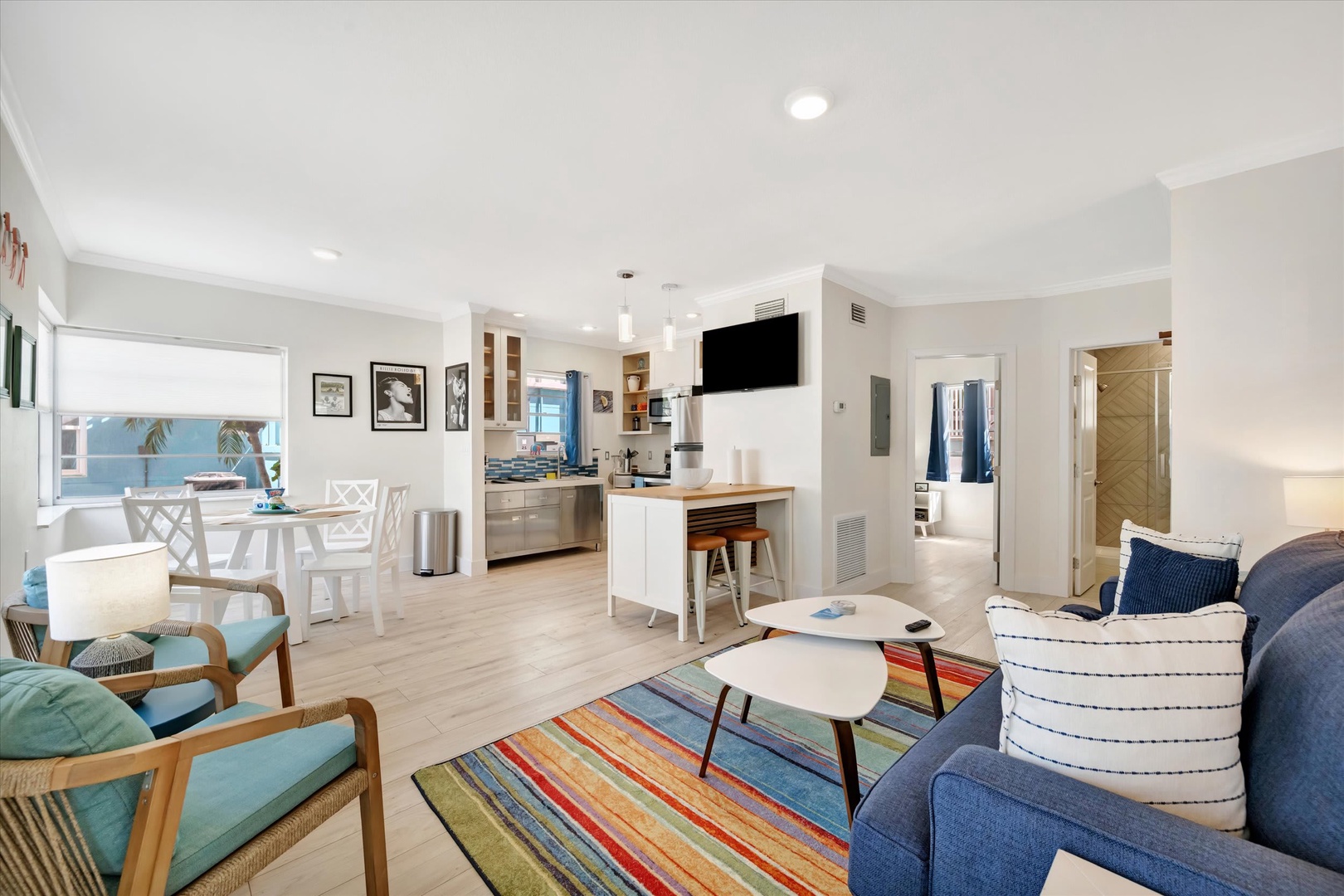 Step into your open-concept retreat, where the living room, kitchen, and dining area blend effortlessly—perfect for gathering or unwinding after a day at the beach.