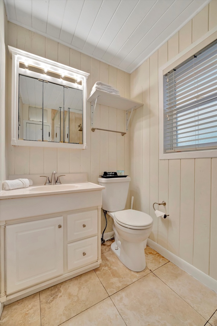 Fresh towels and a crisp, coastal-style bathroom await you, with soft natural light and thoughtful touches that make your stay feel like home.