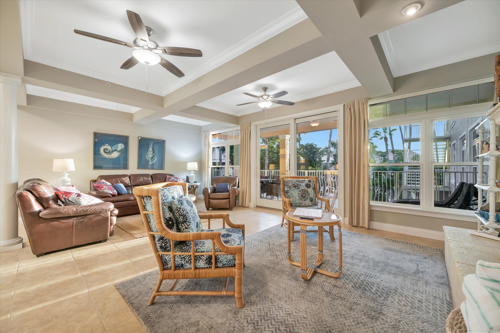 Unwind in your spacious living room, where coffered ceilings and abundant natural light create an airy retreat. Sink into plush seating as ceiling fans keep you cool, and step out to your private balcony to soak in the tropical surroundings.