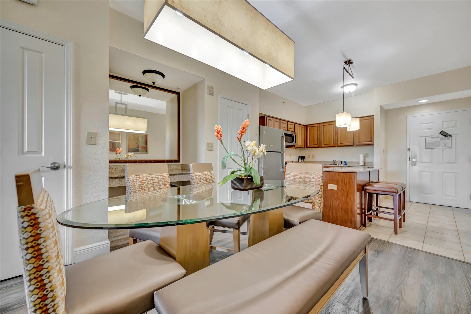 Your open-concept dining and kitchen area is designed for effortless entertaining, with warm wood cabinetry, modern appliances, and a spacious island perfect for morning coffee or casual meals together.