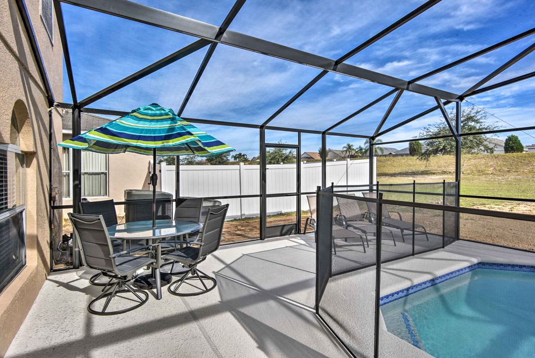 The screened lanai overlooks an expansive Florida landscape, offering your own private oasis with pool, outdoor dining, and endless blue skies overhead.