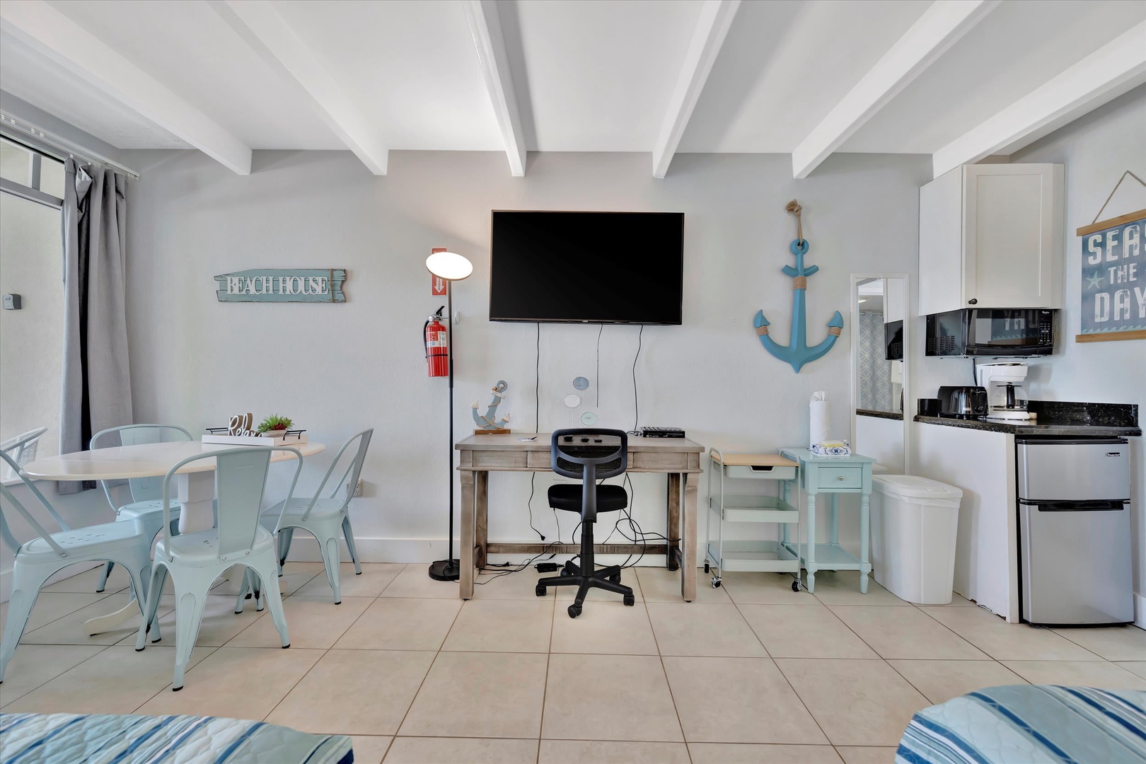 Relax in your bright, beach-themed retreat with charming nautical touches and cozy coastal decor. Everything you need is within easy reach—prepare meals, dine together, or unwind after a day of sun and adventure.